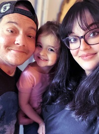 A man with wife and daughter at home after prolonged ECMO treatment and lung transplant.